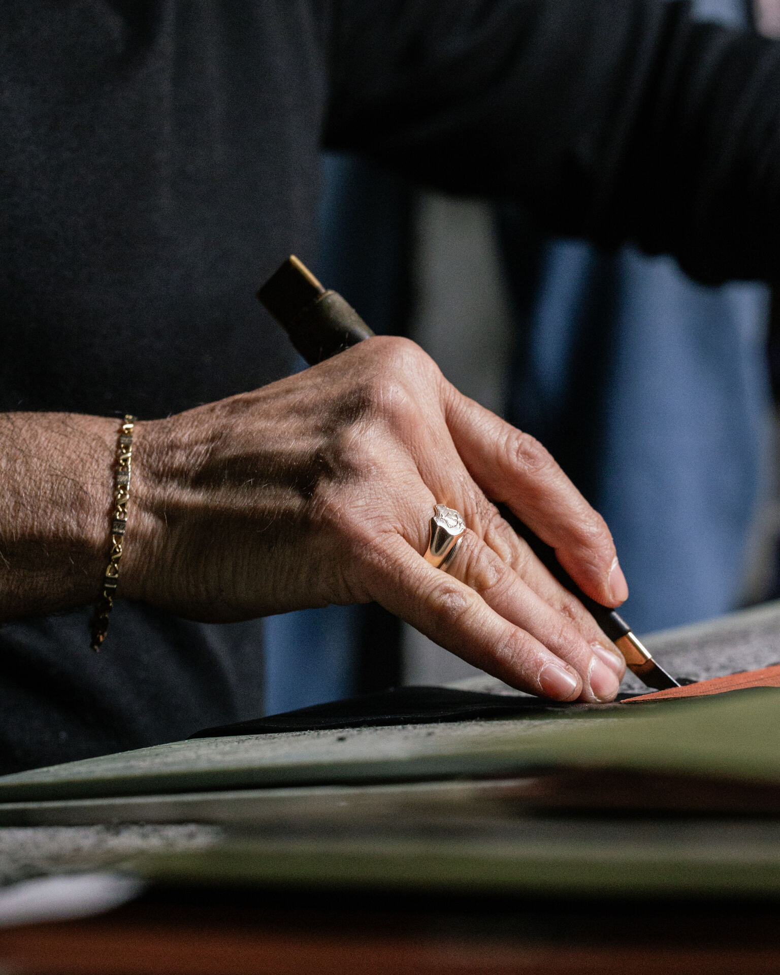 Riva Firenze artisan marking the leather before cutting